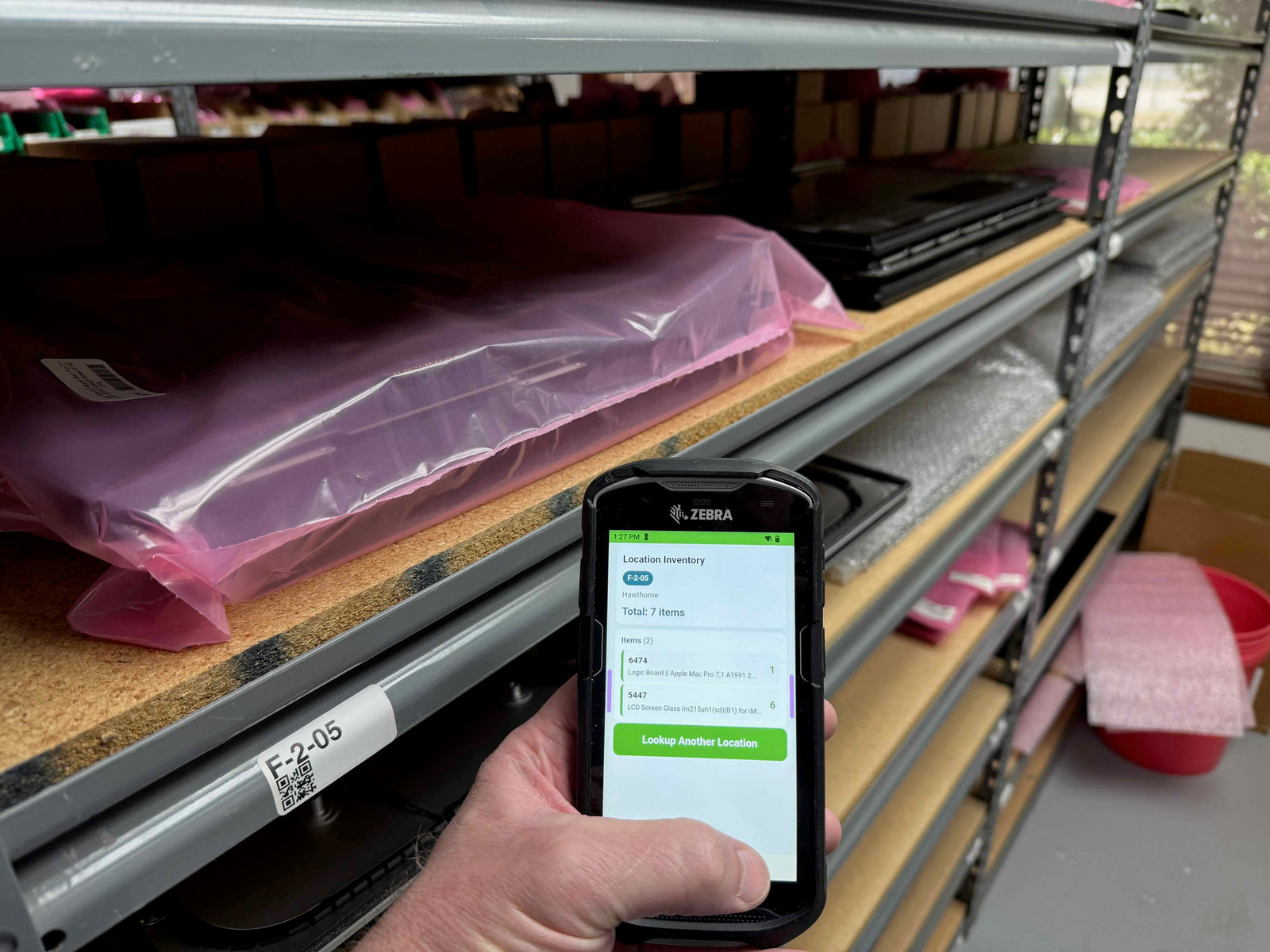 Part Manager Pro handheld scanner performing location inventory lookup on warehouse shelf