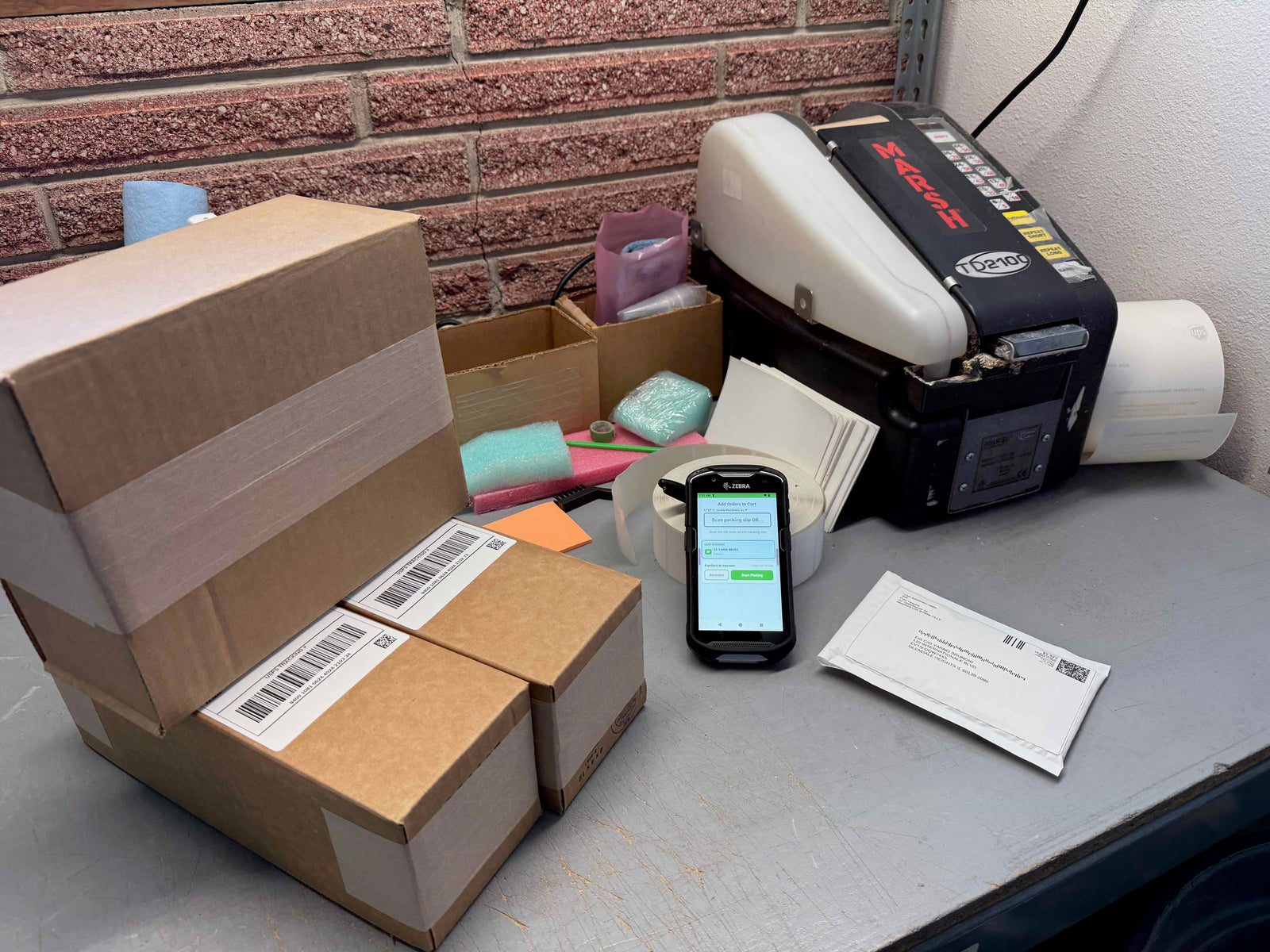 Part Manager Pro shipping station with labeled boxes, thermal label printer, and handheld scanner